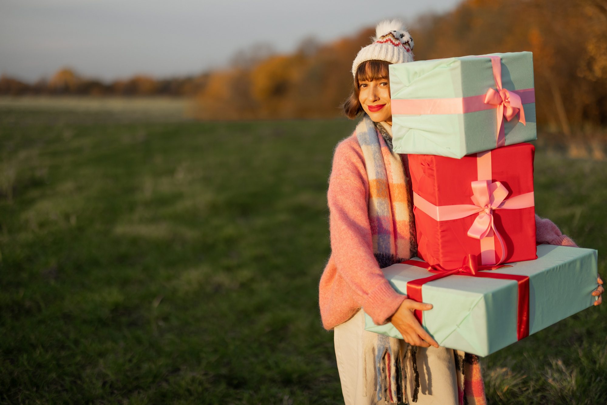 Woman carries New Year's gifts outdoors